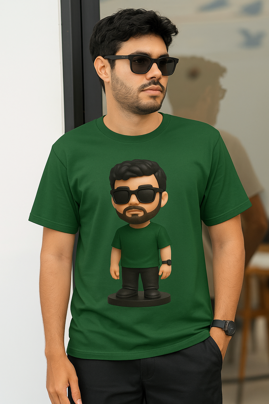 A man wearing a green t-shirt with a fun cartoon character printed on it.