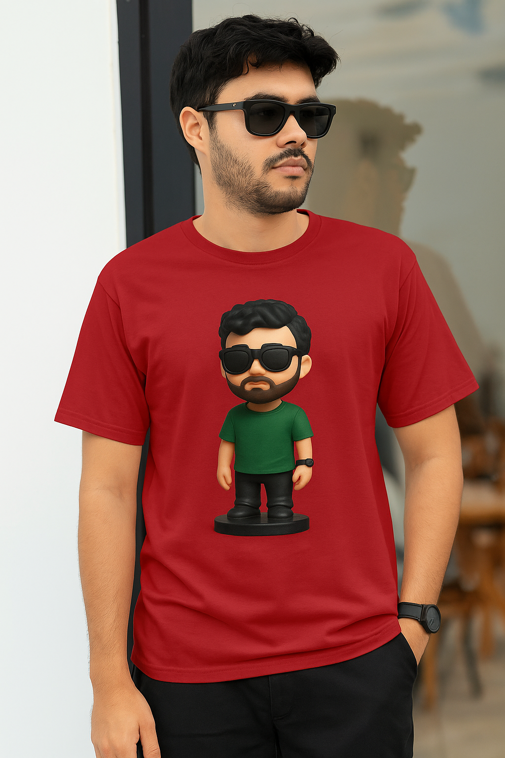 A man shows off his maroon t-shirt adorned with a playful cartoon character design.