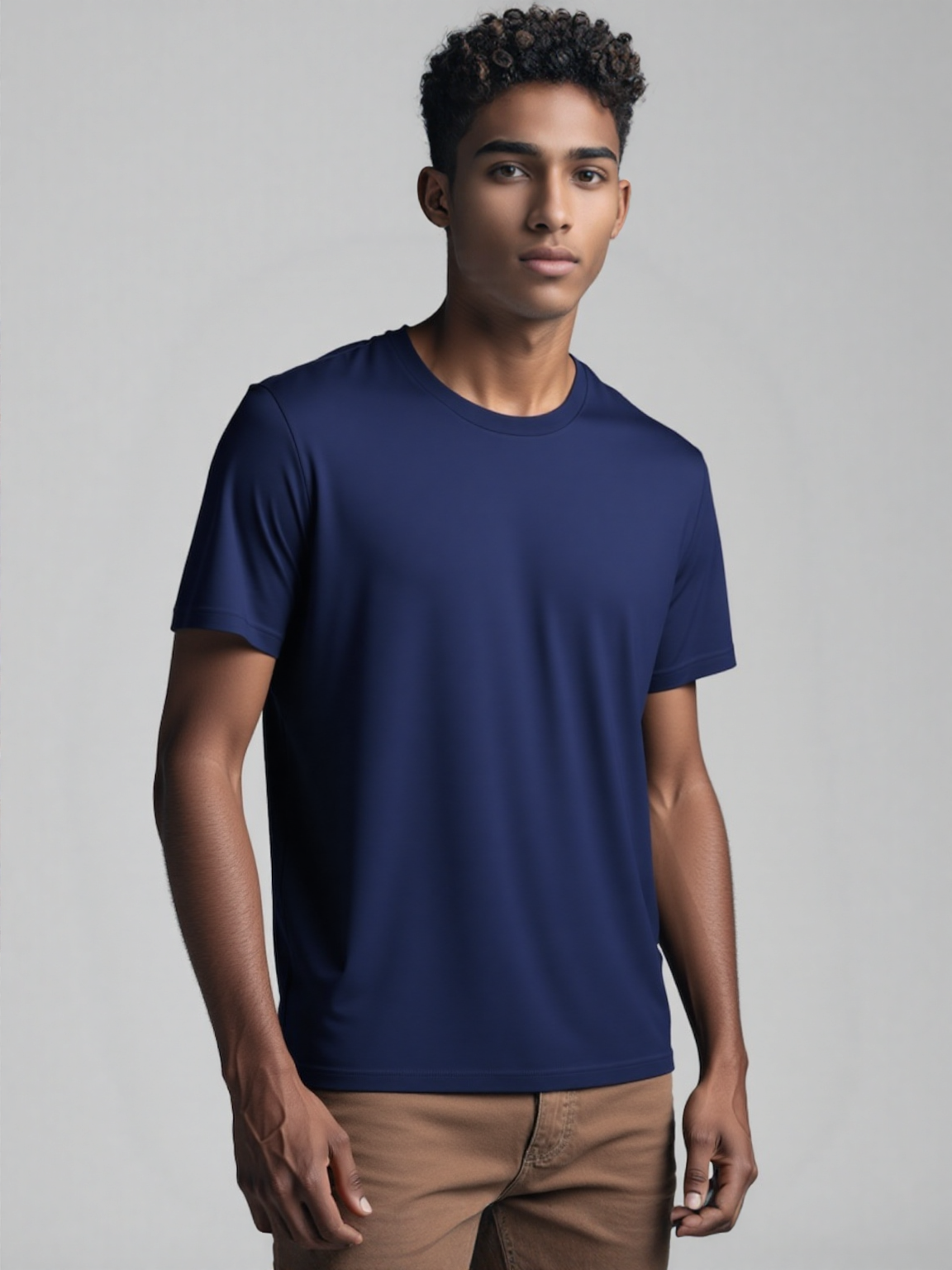 A man dressed in a bright blue t-shirt smiles, embodying a casual
