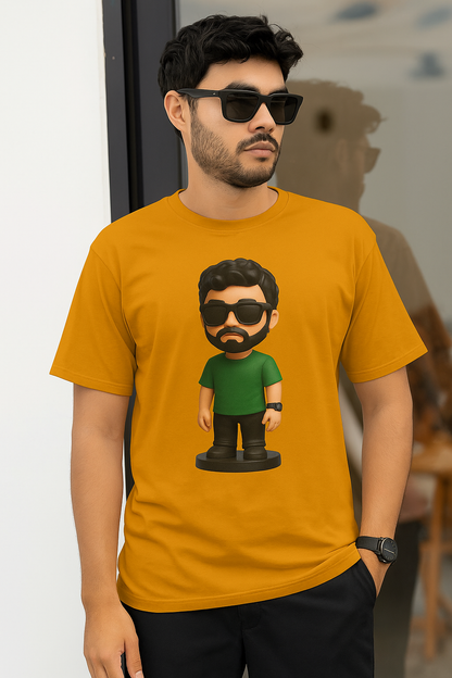 A man in a golden yellow t-shirt featuring a cartoon character smiles at the camera.