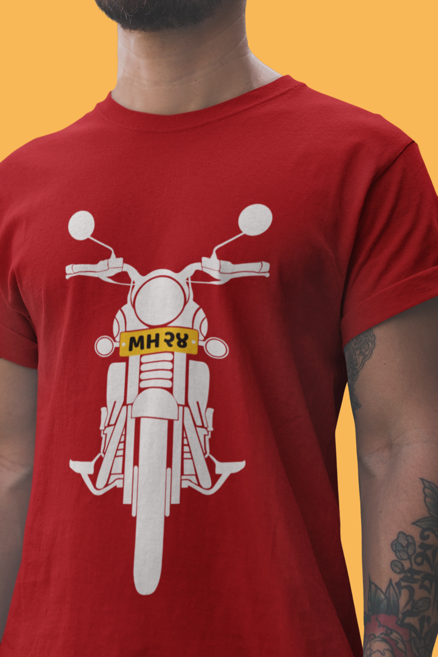 A man dressed in a red t-shirt adorned with a motorcycle image, reflecting a passion for biking culture.