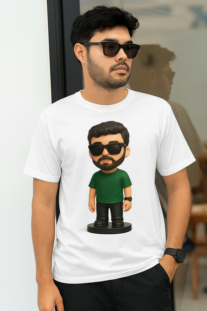 A man in a white t-shirt featuring a cartoon character smiles at the camera.
